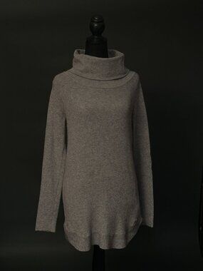A grey cashmere turtleneck is typically a fine-knit or midweight sweater in a ne